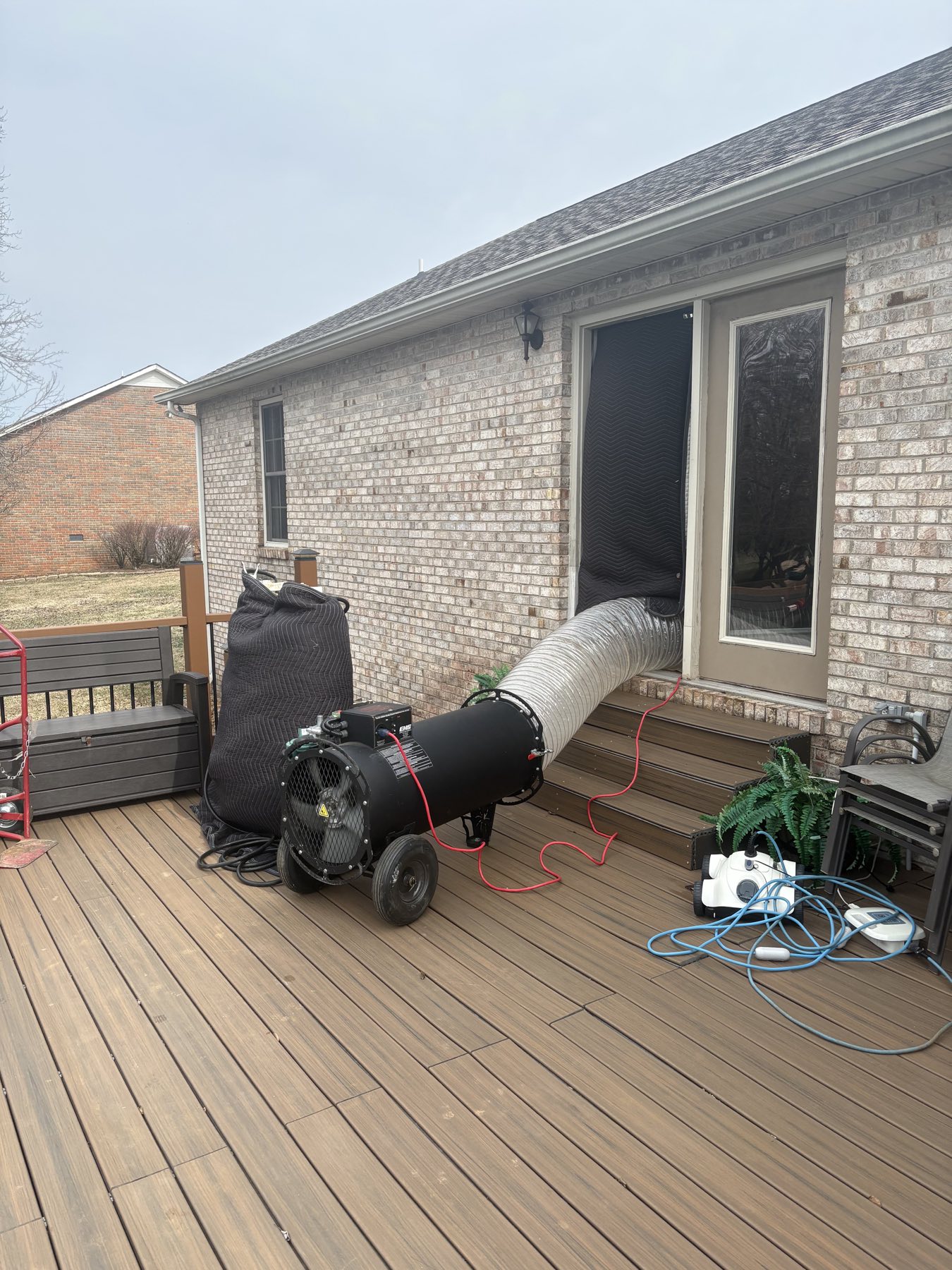 EcoForce heater and duct feeding through a rear deck doorway on a brick house in the Nashville area